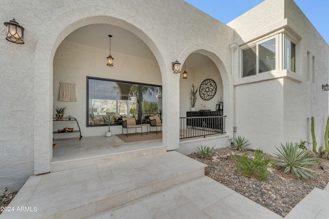 view of exterior entry with a porch