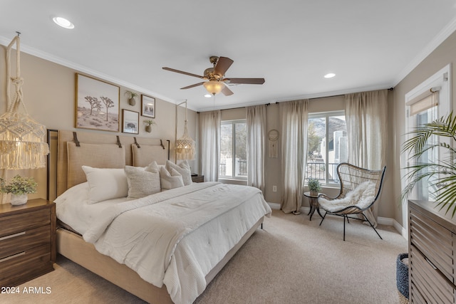 carpeted bedroom featuring ceiling fan and crown molding