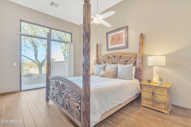 bedroom featuring access to exterior, light hardwood / wood-style floors, and ceiling fan