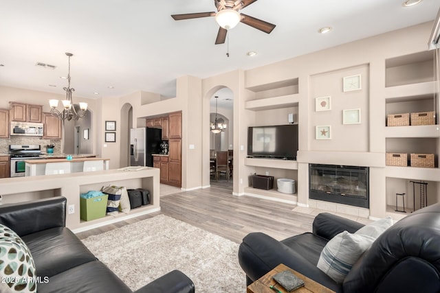 1333 W Deer Creek Rd, Phoenix, AZ 85045 - living room with visible vents, recessed lighting, arched walkways, light wood-style flooring, and ceiling fan with notable chandelier
