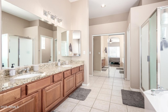1333 W Deer Creek Rd, Phoenix, AZ 85045 - bathroom featuring tile patterned flooring, double vanity, connected bathroom, a shower stall, and a sink