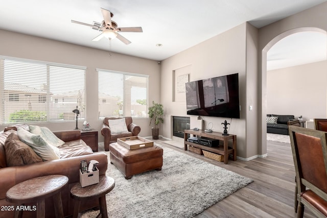 1333 W Deer Creek Rd, Phoenix, AZ 85045 - living area featuring baseboards, arched walkways, a ceiling fan, and wood finished floors