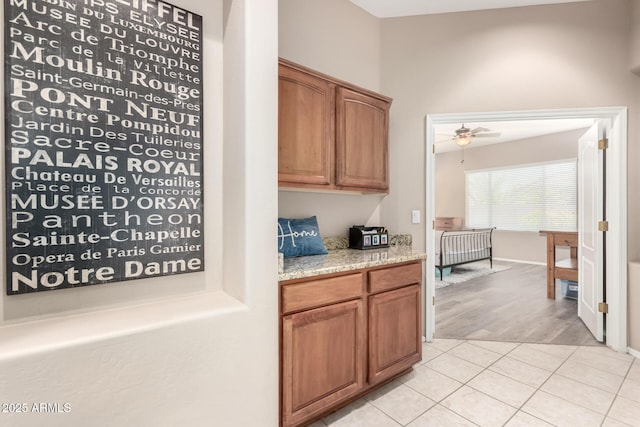 1333 W Deer Creek Rd, Phoenix, AZ 85045 - bar featuring light tile patterned floors, baseboards, and ceiling fan
