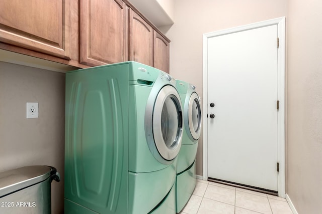 1333 W Deer Creek Rd, Phoenix, AZ 85045 - laundry room featuring cabinet space, baseboards, washing machine and dryer, and light tile patterned floors