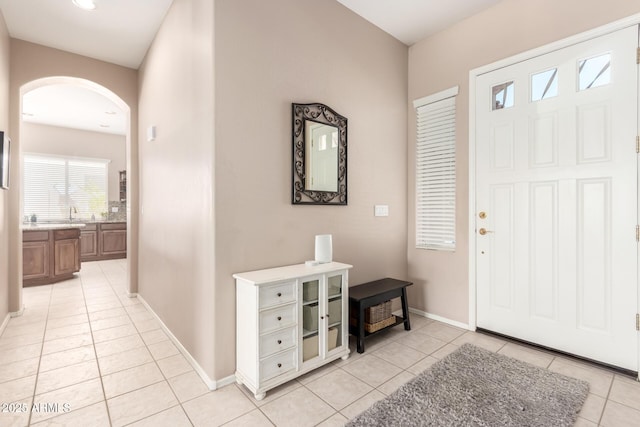 1333 W Deer Creek Rd, Phoenix, AZ 85045 - entrance foyer featuring light tile patterned floors, arched walkways, baseboards, and recessed lighting