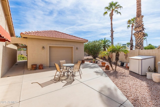 view of patio / terrace featuring an outbuilding and a garage