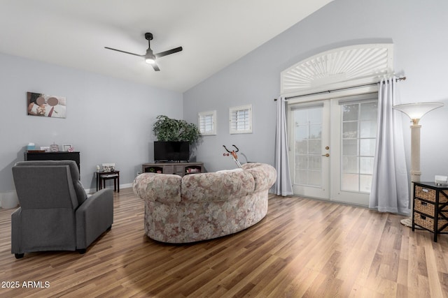 living room featuring lofted ceiling, a ceiling fan, wood finished floors, and french doors