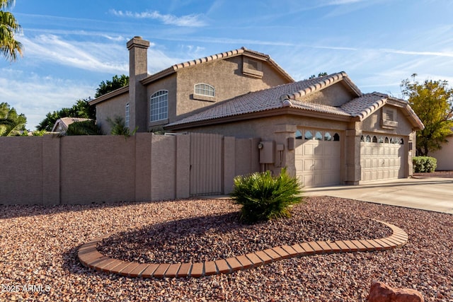 view of property exterior featuring a chimney, stucco siding, concrete driveway, fence, and a garage