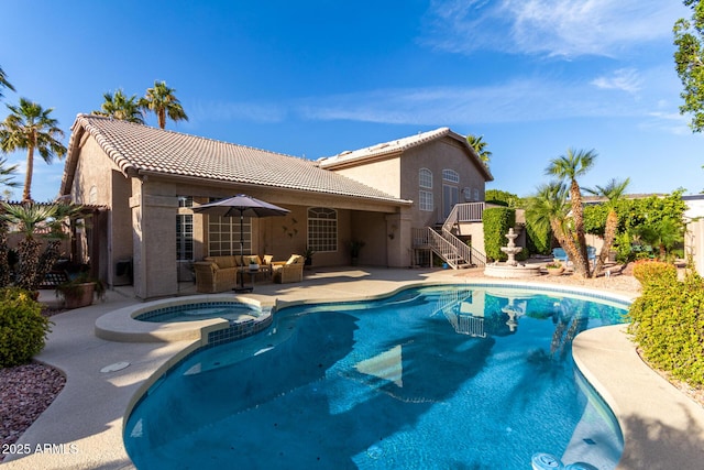 view of pool with a pool with connected hot tub, a patio, an outdoor hangout area, and stairs