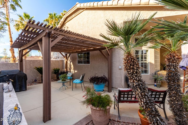 view of patio / terrace featuring grilling area, fence, and a pergola