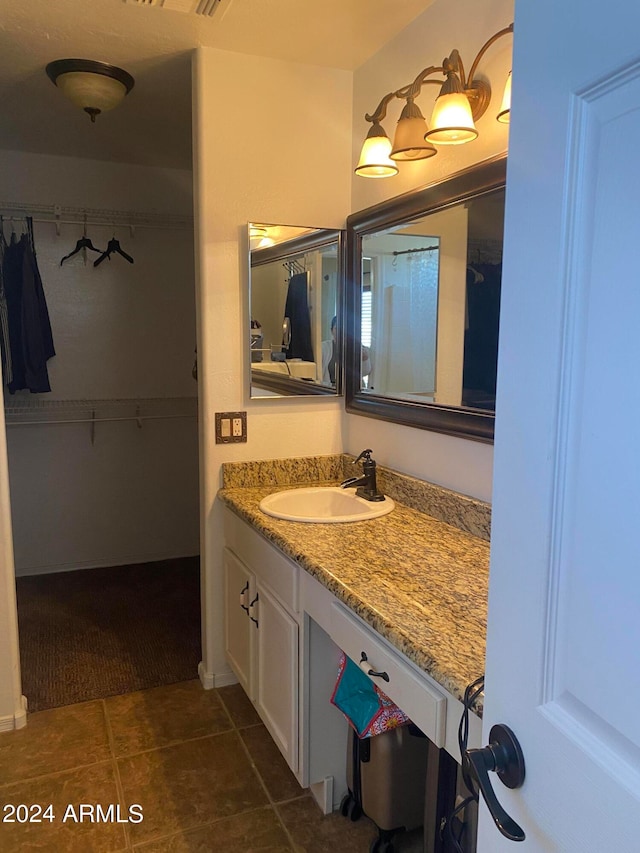 bathroom featuring tile patterned flooring and vanity