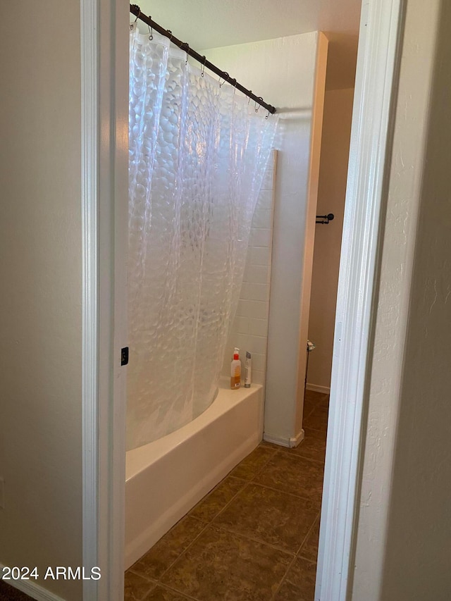 bathroom with tile patterned floors and shower / tub combo