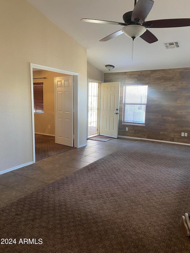 empty room with carpet floors, ceiling fan, and lofted ceiling