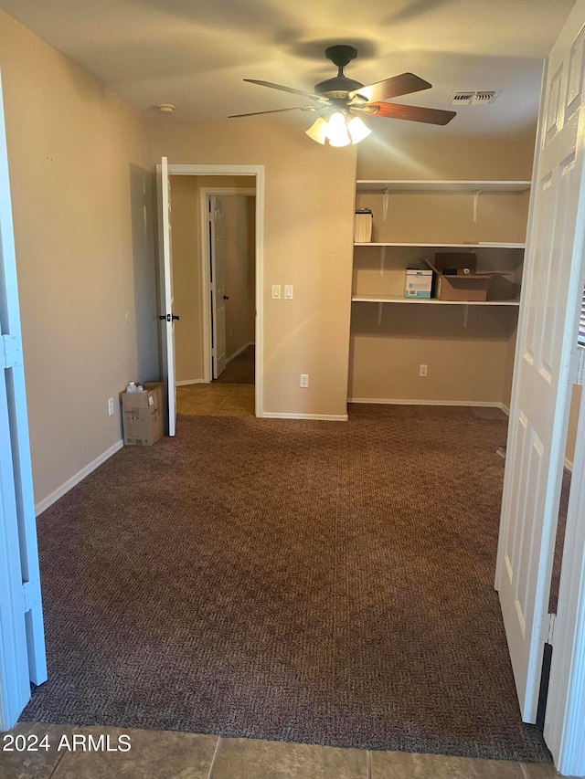 spare room with carpet and ceiling fan