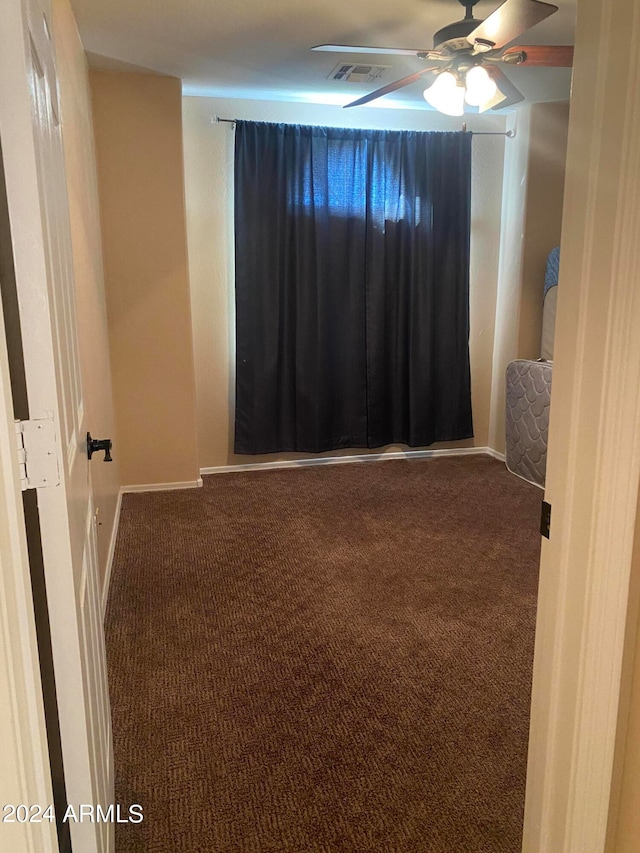 spare room with ceiling fan and carpet flooring