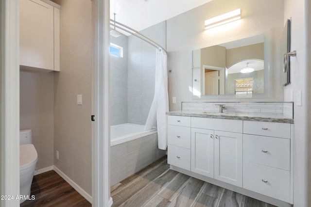 full bathroom with vanity, toilet, wood-type flooring, and shower / tub combo with curtain