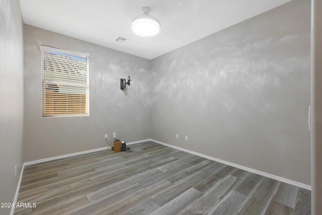 unfurnished room featuring hardwood / wood-style flooring