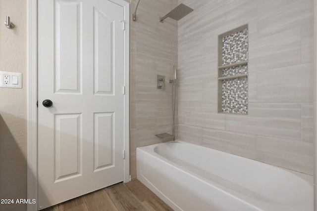 bathroom featuring hardwood / wood-style floors and tiled shower / bath combo