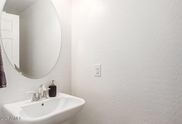 bathroom with a sink and a textured wall