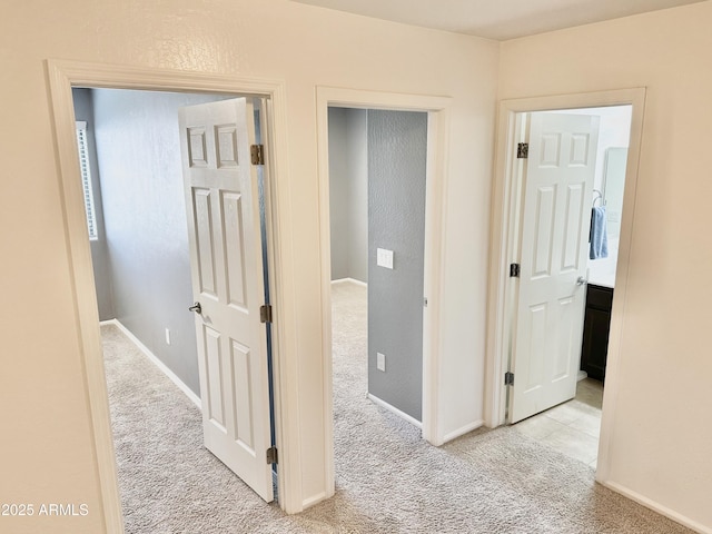 hall with carpet and baseboards