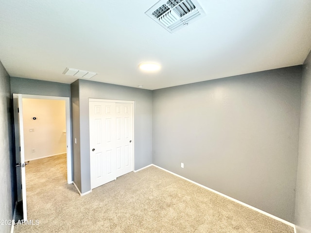 basement featuring carpet floors, visible vents, and baseboards