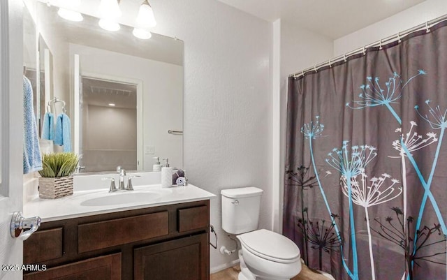 bathroom featuring a shower with curtain, vanity, and toilet