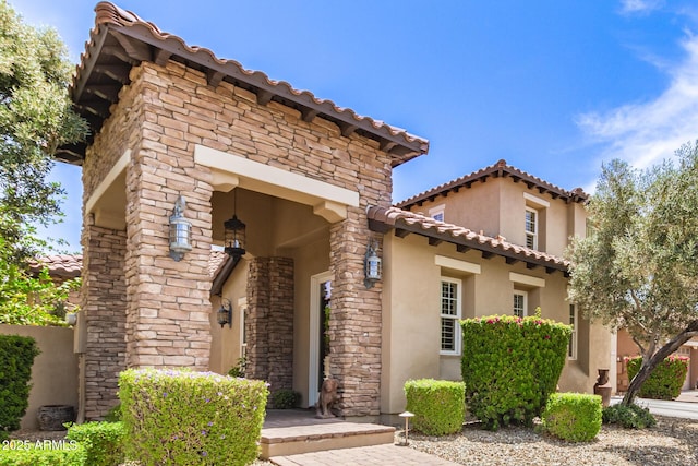 3441 S Halsted Pl, Chandler, AZ 85286 - view of front of home with stucco siding, a tile roof, and stone siding