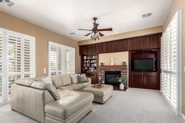 3441 S Halsted Pl, Chandler, AZ 85286 - living room with a ceiling fan, light colored carpet, and a fireplace