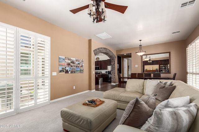 3441 S Halsted Pl, Chandler, AZ 85286 - carpeted living area with a ceiling fan, healthy amount of natural light, baseboards, and arched walkways
