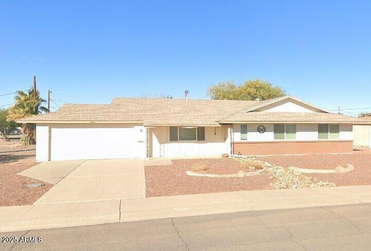 ranch-style house featuring concrete driveway and an attached garage