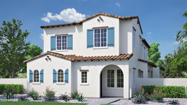 mediterranean / spanish-style house featuring a fenced front yard, stucco siding, and a tiled roof