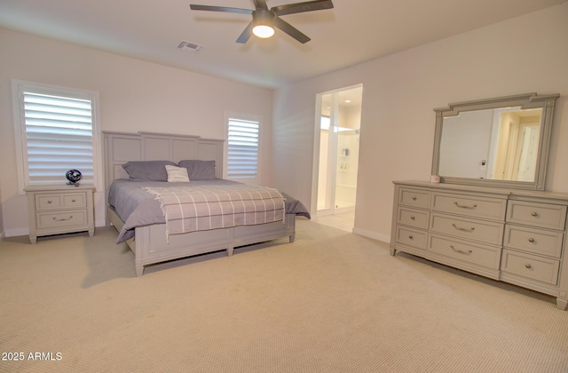 carpeted bedroom featuring ceiling fan and ensuite bathroom