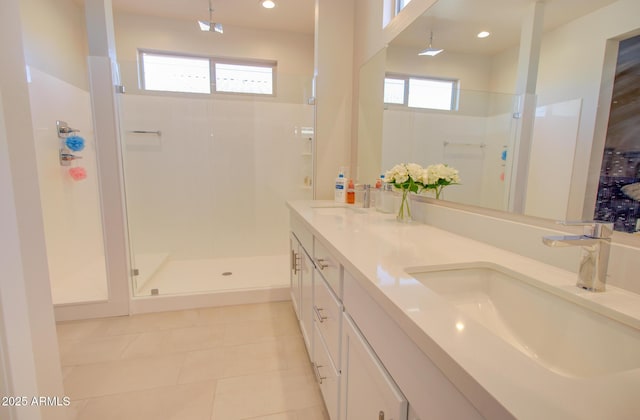 bathroom featuring vanity, tile patterned floors, and a shower