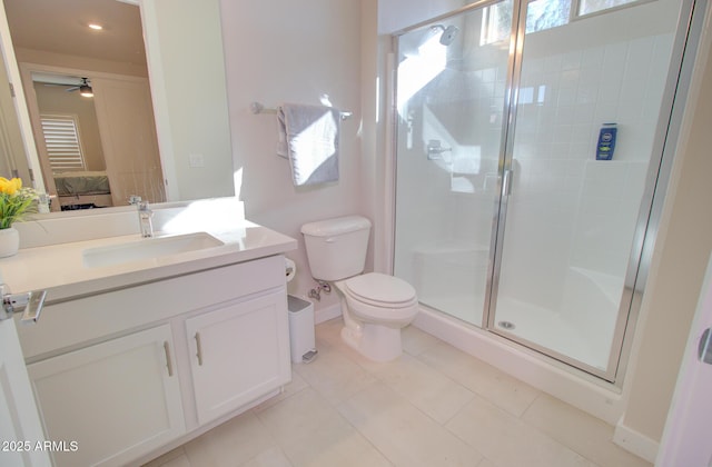 bathroom with toilet, a shower with door, tile patterned floors, ceiling fan, and vanity