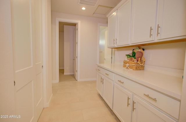 kitchen featuring white cabinetry and light tile patterned floors