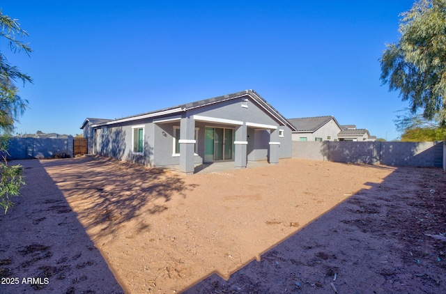 back of property with a patio