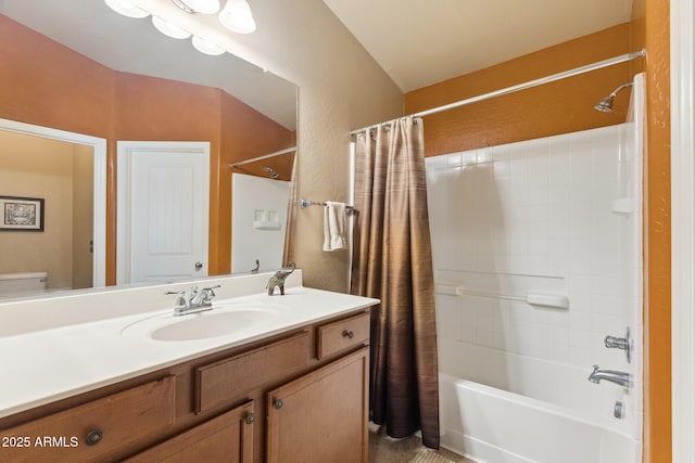 bathroom featuring toilet, shower / tub combo with curtain, and vanity