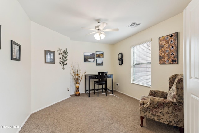 carpeted office space featuring visible vents, ceiling fan, and baseboards