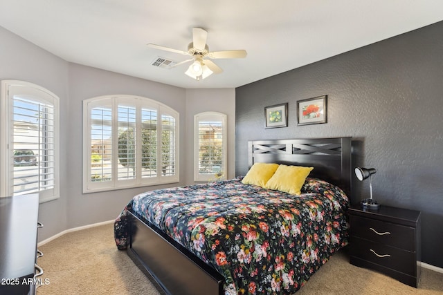 carpeted bedroom featuring visible vents, ceiling fan, and baseboards