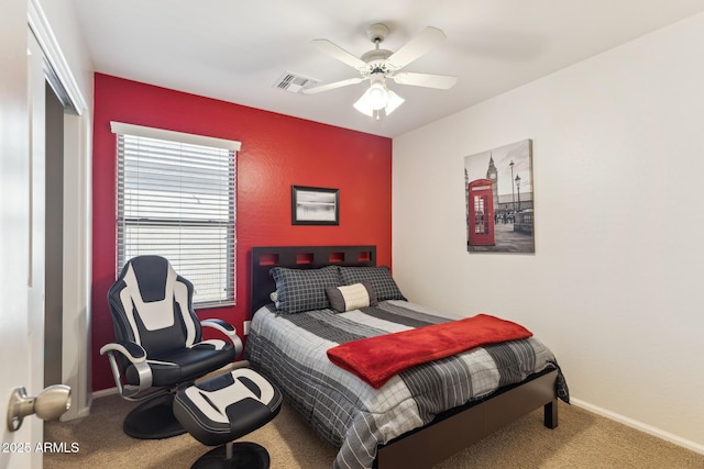 carpeted bedroom featuring a ceiling fan, a closet, visible vents, and baseboards