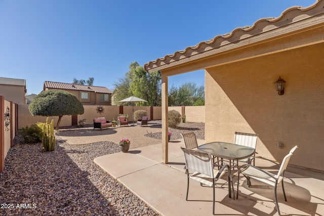 view of patio with a fenced backyard and outdoor dining area