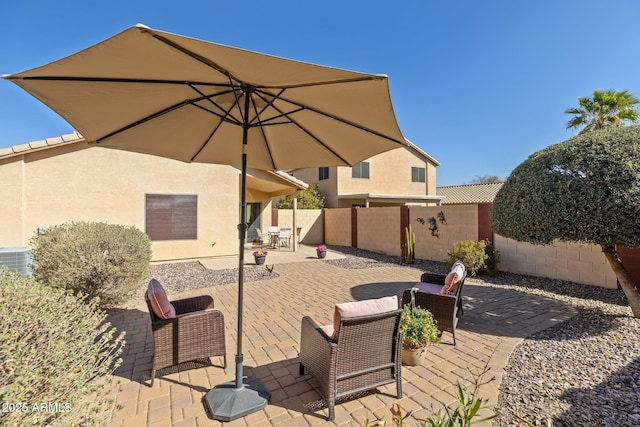 view of patio / terrace with a fenced backyard and central air condition unit