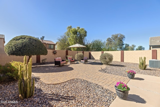 view of yard with cooling unit, a fenced backyard, and a patio