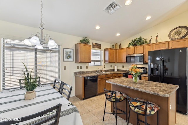 kitchen featuring visible vents, light tile patterned flooring, vaulted ceiling, a sink, and black appliances