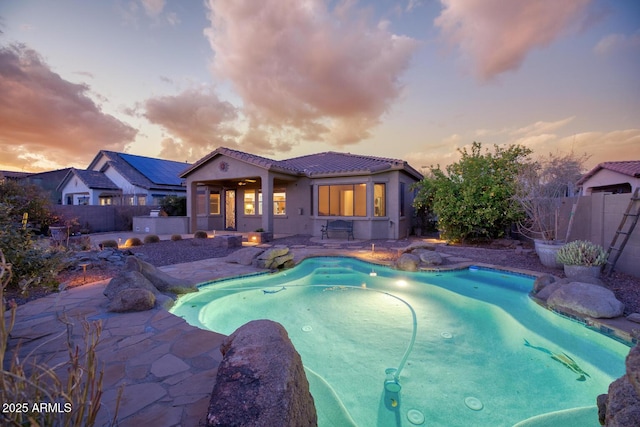 18391 W Verdin Rd, Goodyear, AZ 85338 - pool at dusk with a fenced backyard and a patio area