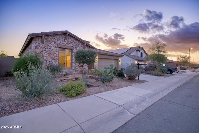 18391 W Verdin Rd, Goodyear, AZ 85338 - view of front of property featuring stone siding, a garage, and a tiled roof