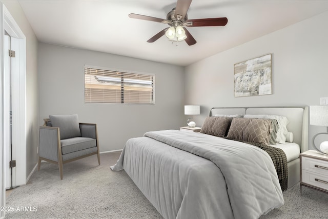 bedroom featuring ceiling fan, light colored carpet, and baseboards