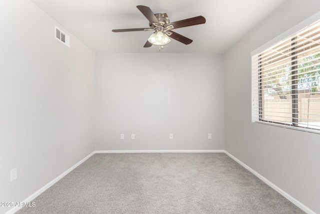 unfurnished room with baseboards, visible vents, ceiling fan, and carpet floors