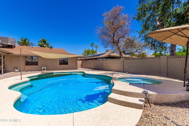 view of swimming pool featuring a patio, fence, a pool with connected hot tub, and central AC unit