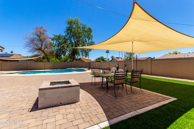 view of patio featuring a fenced in pool, a fire pit, and a fenced backyard
